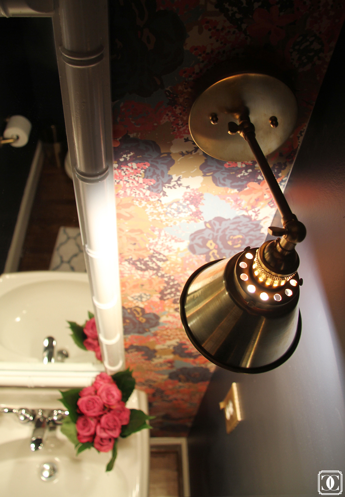 brass lighting, floral wallpaper, bamboo mirror, navy walls 