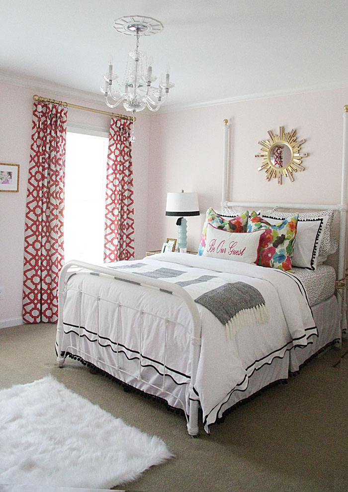 colorful guest room, DIY guest room, chandelier, colorful bedding, colorful drapes, gold sunburst mirror, fur rug 