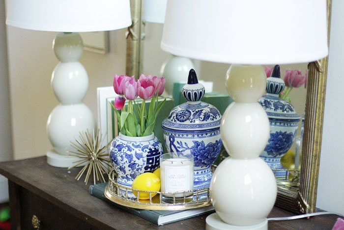 entry way, brass bamboo tray, blue and white ginger jars, white lamps, gold urchin