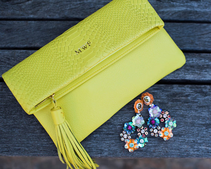 Add a pop of neon with this convertible clutch and statement earrings!