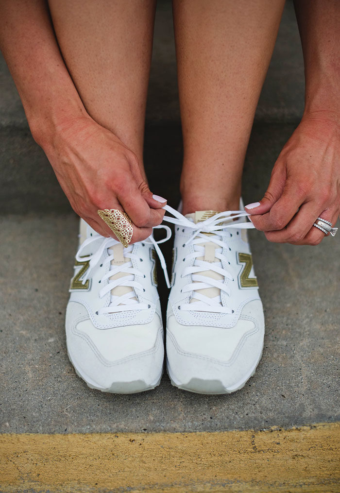White and gold New Balance sneakers for women