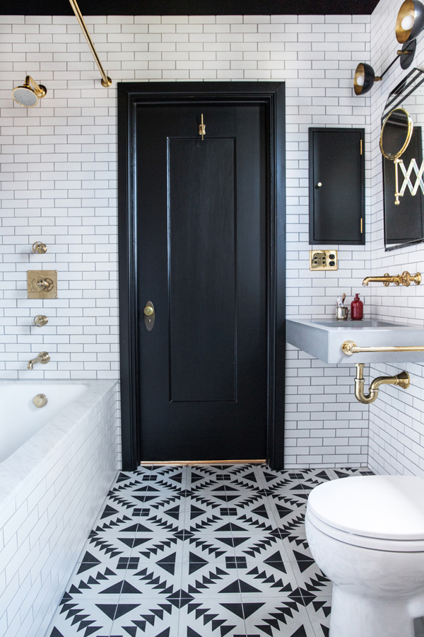 Gorgeous rustic modern bathroom with white tile and brass hardware