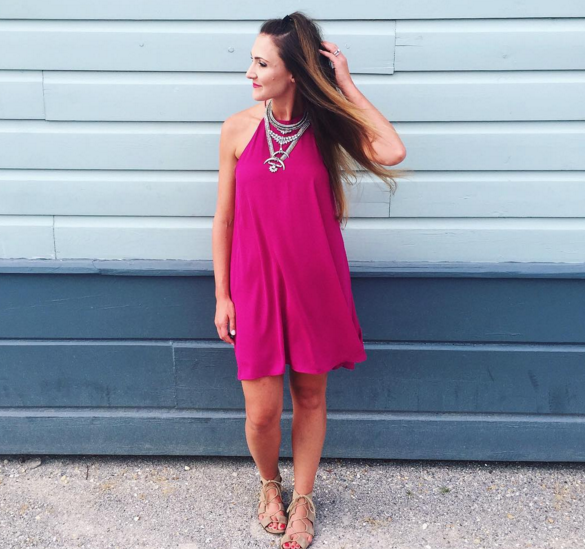 Blogger Mallory Fitzsimmons of Style Your Senses wears a pink trapeze dress and statement necklace in Seaside, Florida