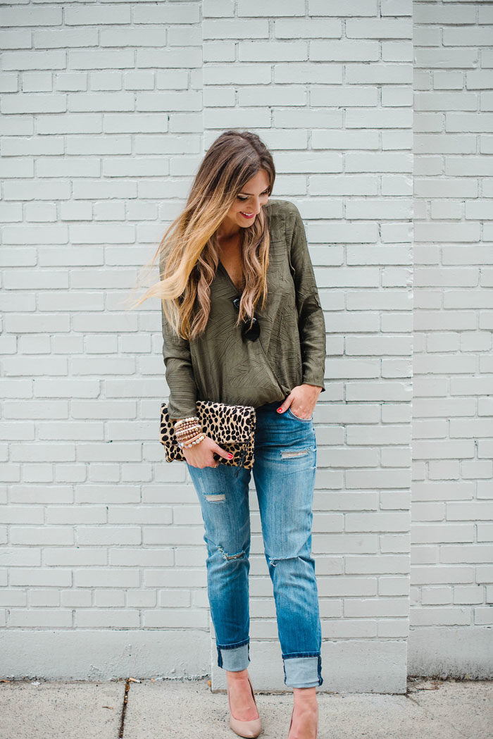 Blogger Mallory Fitzsimmons of Style Your Senses styles distressed boyfriend jeans with a Cooper and Ella crossover top and a cheetah clutch. 