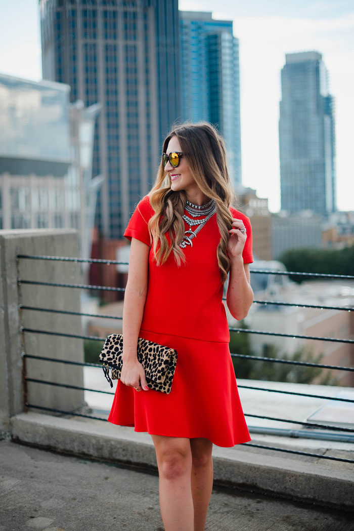 Red Donna Morgan swing dress paired with booties for a chic Fall transition outfit.