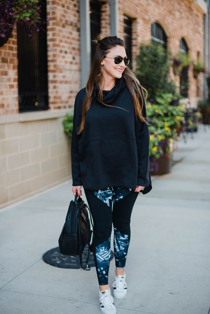 Blogger Mallory Fitzsimmons of Style Your Senses wears Zella tights and a Northface Poncho for a "cool mom" athleisure look.