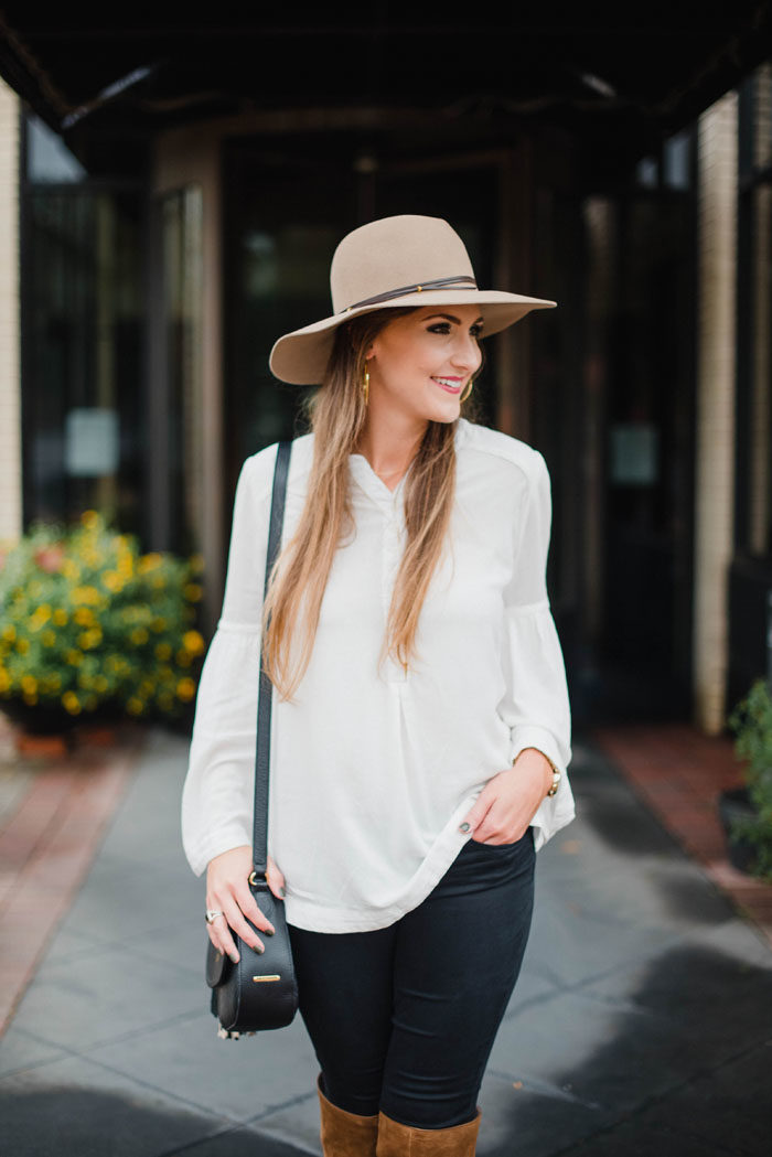 Blogger Mallory Fitzsimmons of Style Your Senses wears a Free People bell sleeved blouse, over the knee boots and tan felt hat.