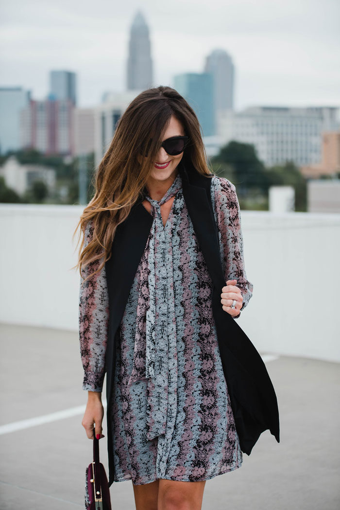 Blogger Mallory Fitzsimmons of Style Your Senses wears a Cece by Cynthia Steffe paisley dress with a black trench vest and Vince Camuto mid calf booties