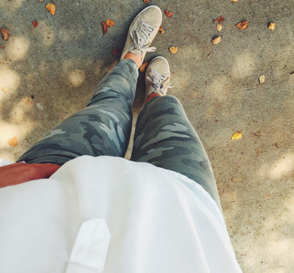 Camo skinny jeans with sneakers and an ivory tunic
