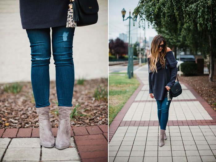 Blogger Mallory Fitzsimmons of Style Your Senses wears an off the shoulder sweater and grey mid calf booties for a transitional outfit.
