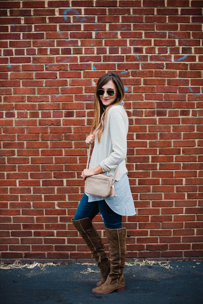 Blogger Mallory Fitzsimmons of Style Your Senses wears a tunic layered sweaters with Dolce Vita over the knee suede boots for an easy and chic on-the-go mom outfit.