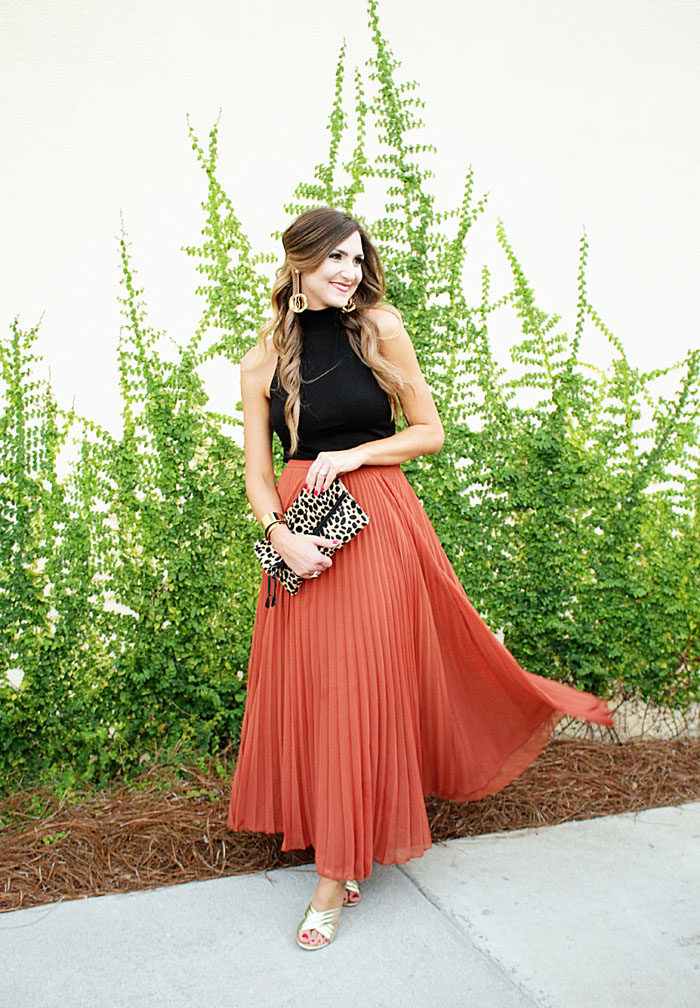 Long pleated maxi skirt with gold heels and a leopard clutch