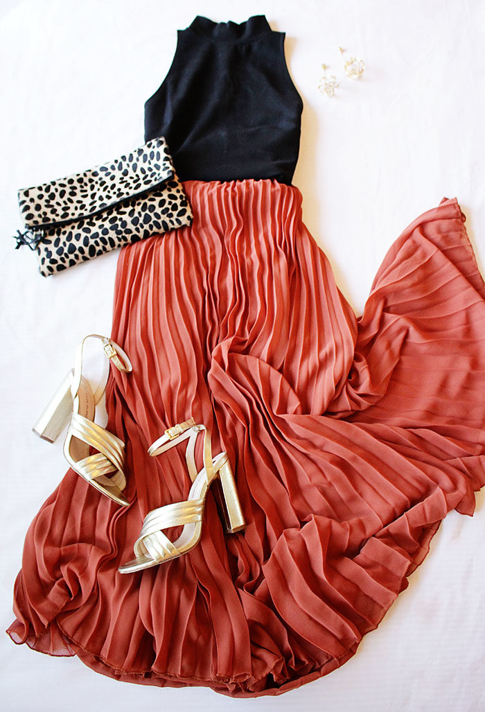 Long pleated maxi skirt with gold heels and a leopard clutch