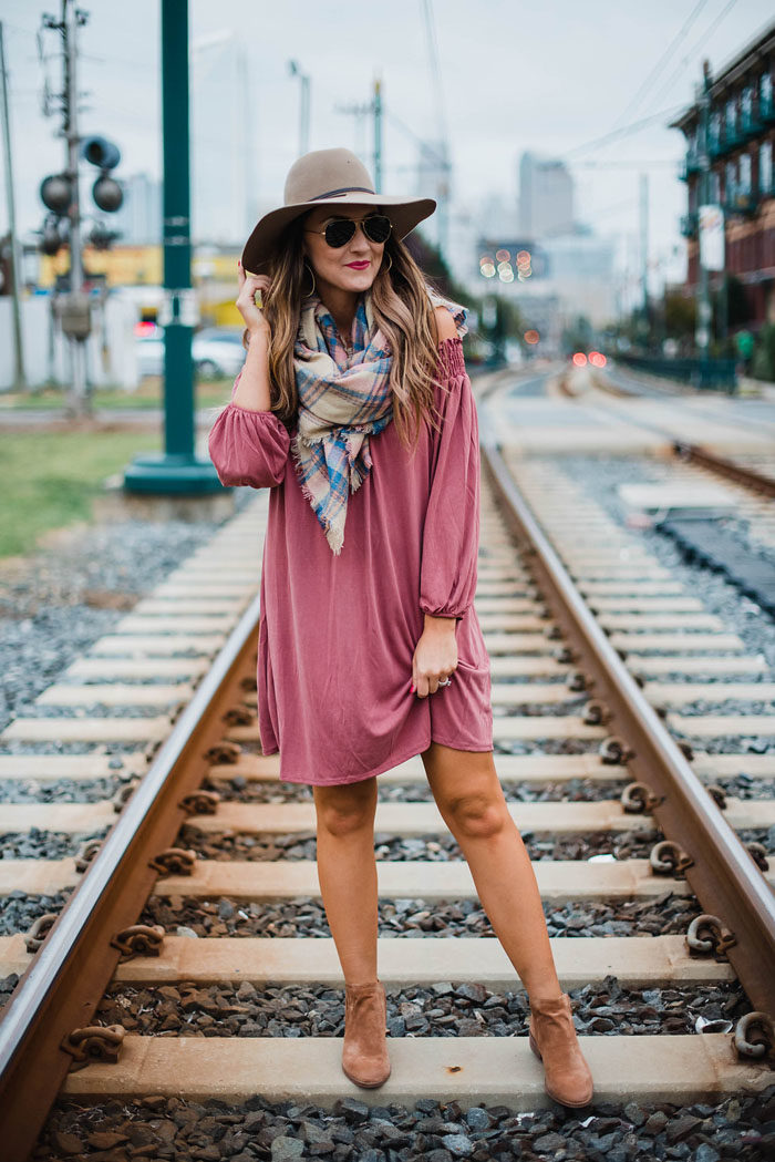 Blogger Mallory Fitzsimmons of Style Your Senses wears a rose pink off the shoulder dress with a felt hat, blanket scarf and Dolce Vita ankle booties