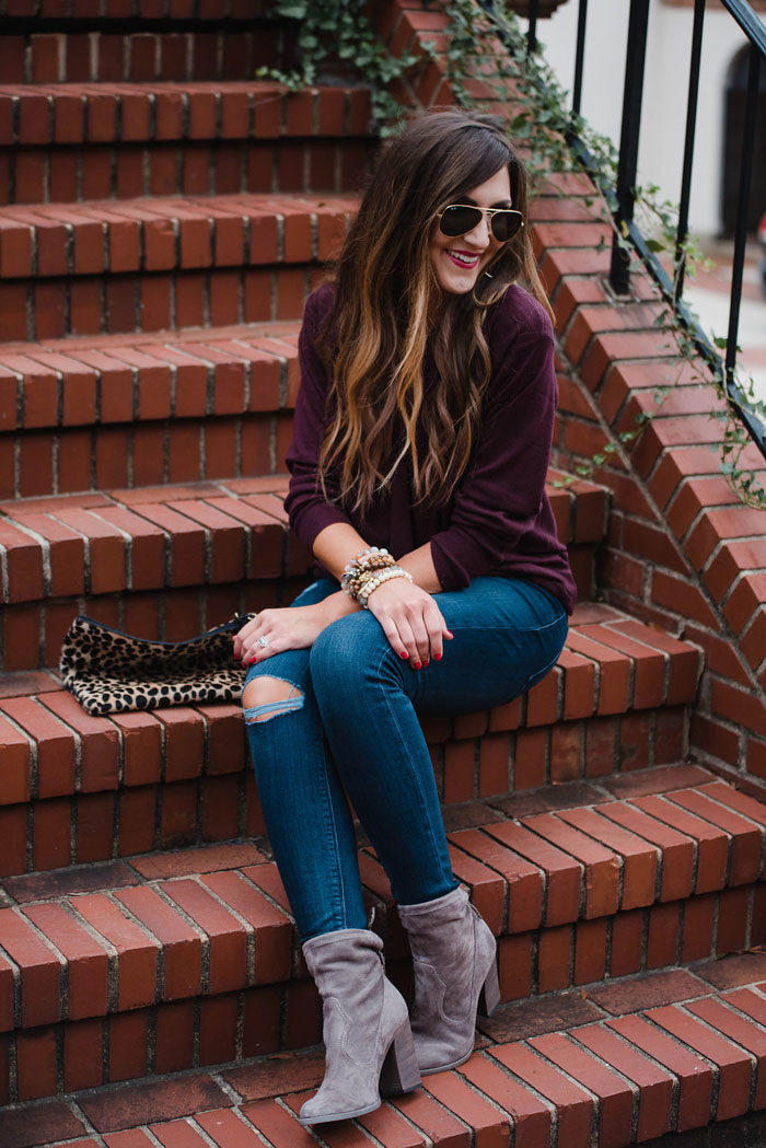 Blogger Mallory Fitzsimmons of Style Your Senses is wearing a merlot wrap front sweater and distressed skinny jeans for a Fall casual outfit that's chic and comfortable