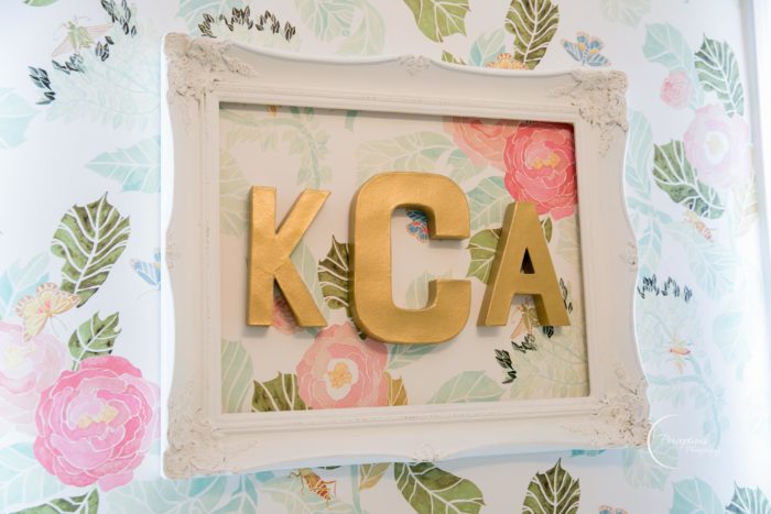 Gorgeous gold monogram over floral watercolor wallpaper from Anthropologie