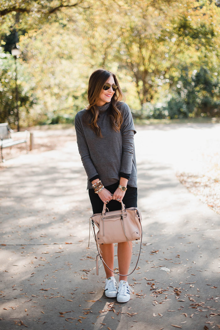 Blogger Mallory Fitzsimmons of Style Your Senses shows how to layer with a black body con dress and a lightweight turtleneck for an athleisure look that's comfortable and casual