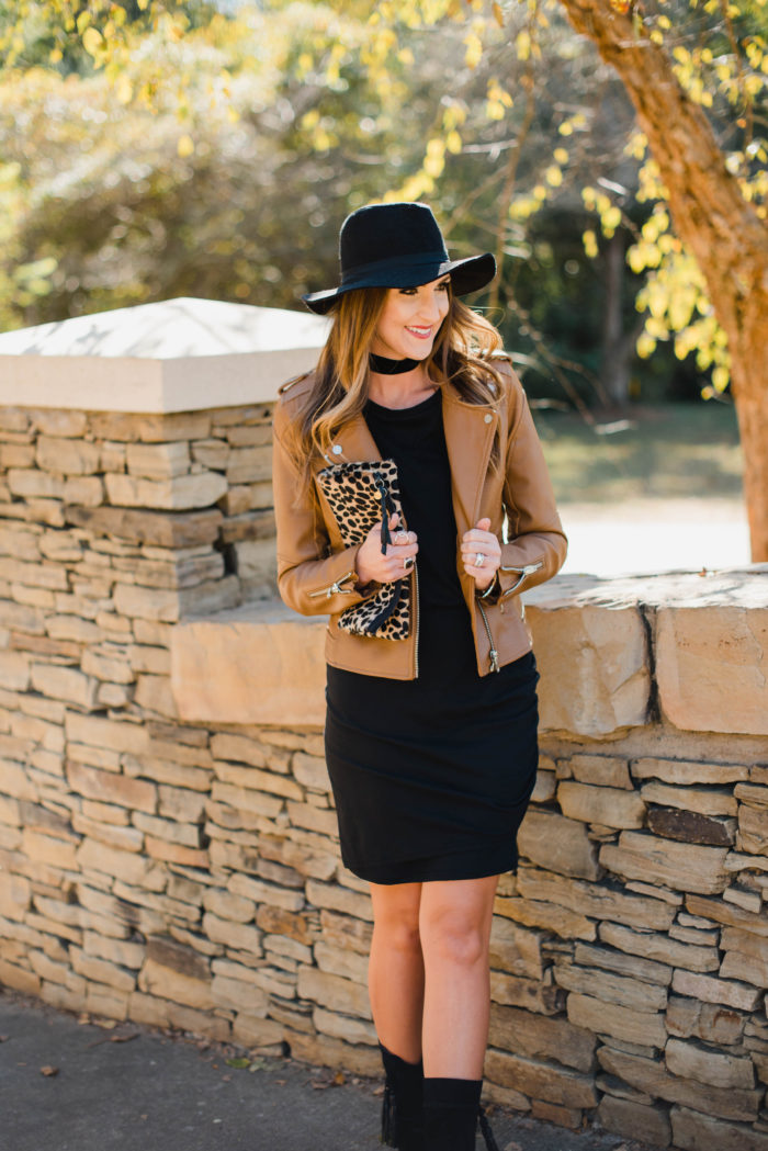 Blogger Mallory Fitzsimmons of Style Your Senses wears a black body con dress with a gorgeous leather moto jacket, felt hat and choker for a dressed up Fall transition look.