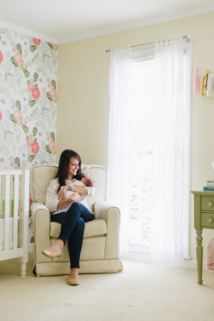 Beautiful baby girl nursery with floral wallpaper from Anthropologie and gold monogram over the crib