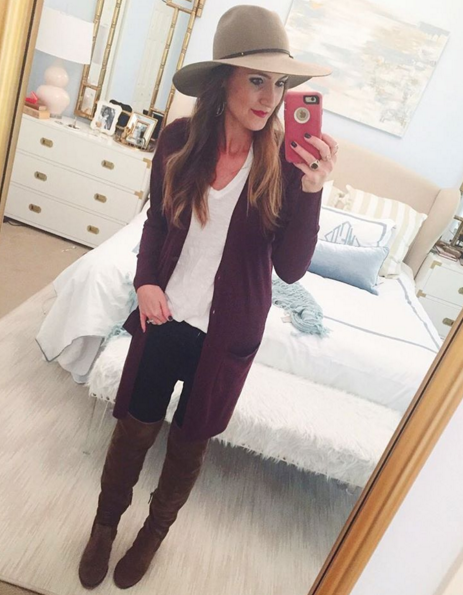 Blogger Mallory Fitzsimmons of Style Your Senses wears a plum tunic cardigan with over the knee boots and a felt hat for a casual Fall transition look