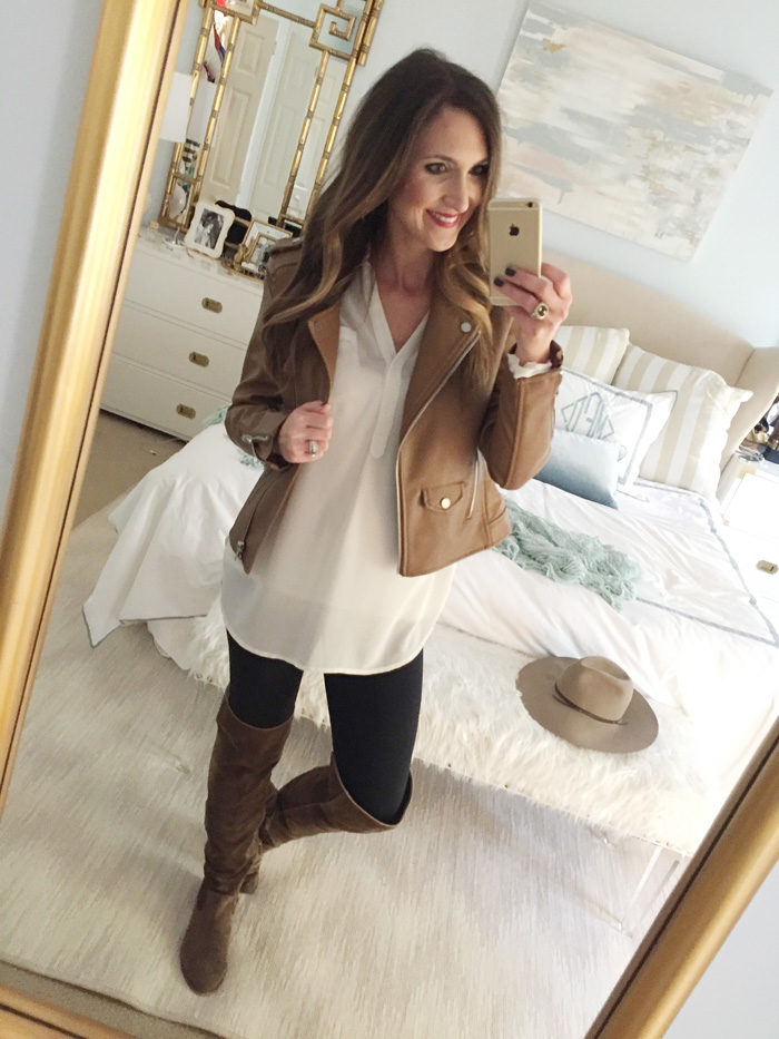 Blogger Mallory Fitzsimmons of Style Your Senses wears an ivory tunic, faux leather vest, skinny jeans and over the knee boots for a festive Thanksgiving outfit idea