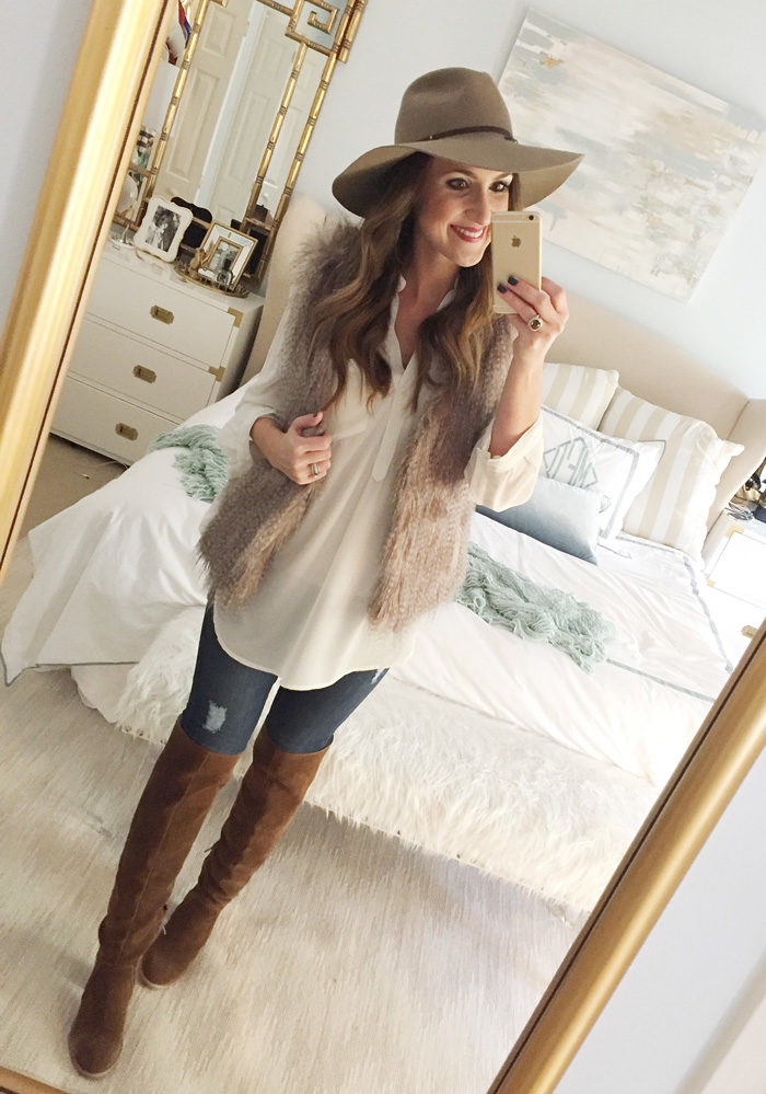 Blogger Mallory Fitzsimmons of Style Your Senses wears an ivory tunic, faux fur vest, skinny jeans and over the knee boots for a festive Thanksgiving outfit idea