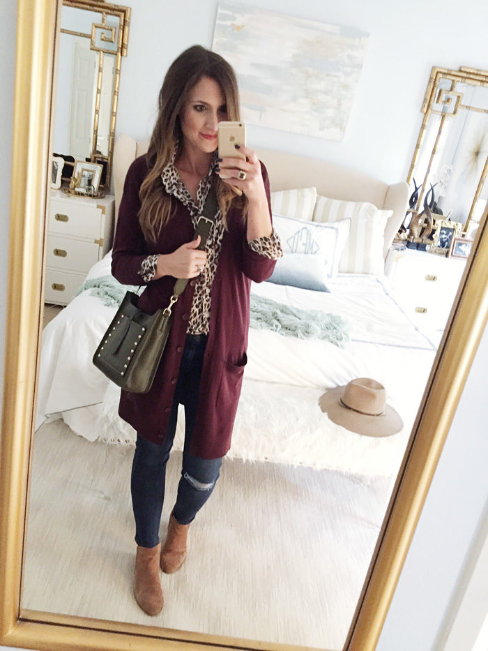 Blogger Mallory Fitzsimmons of Style Your Senses wears a plum tunic cardigan with skinny jeans and over the knee boots for a festive Thanksgiving outfit idea