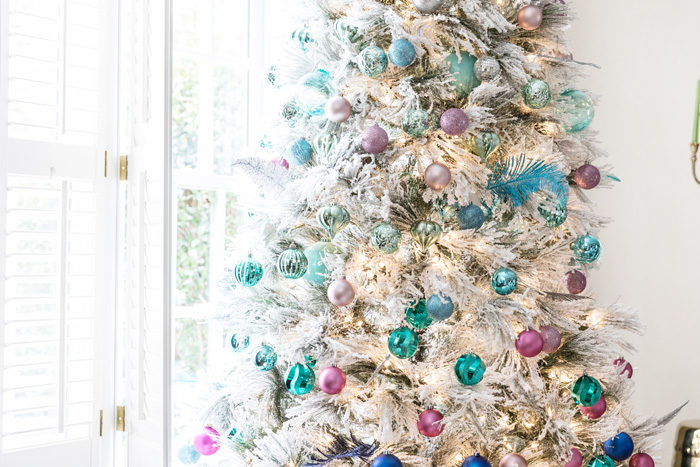 Blogger Mallory Fitzsimmons of Style Your Senses shares her Holiday Home Tour that includes this gorgeous flocked Christmas Tree with blue and pink ornaments - Our Holiday Home Tour featured by popular Texas lifestyle blogger, Style Your Senses