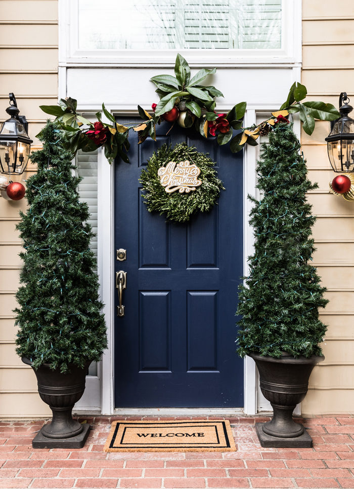 Blogger Mallory Fitzsimmons of Style Your Senses shares her Holiday Home Tour which includes these DIY Christmas Tree planters, gorgeous magnolia garland and boxwood wreath on the front door
