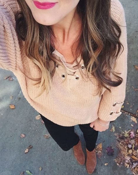 Casual outfit inspiration with lace up sweater and black skinny jeans