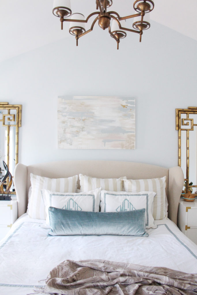 Beautiful, neutral master bedroom with accents of dusty blue and gold