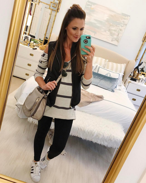 On the go mom style, a stripe tunic, puffer vest, leggings and comfy sneakers
