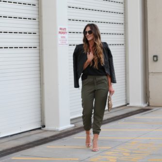 Jogger pants, leather jacket, prada sunglasses, leopard clutch