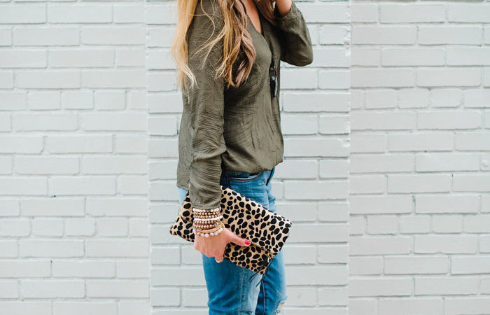 Blogger Mallory Fitzsimmons of Style Your Senses styles distressed boyfriend jeans with a Cooper and Ella crossover top and a cheetah clutch.