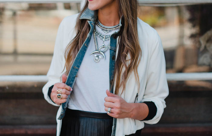 Blogger Mallory Fitzsimmons of Style Your Senses wears a J. Crew pleated leather skirt and bomber jacket as a transitional Fall outfit.