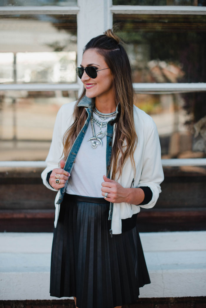 Blogger Mallory Fitzsimmons of Style Your Senses wears a J. Crew pleated leather skirt and bomber jacket as a transitional Fall outfit.