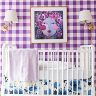 Bright and Bold baby girl nursery design with buffalo check wallpaper, floral fabric and abstract art